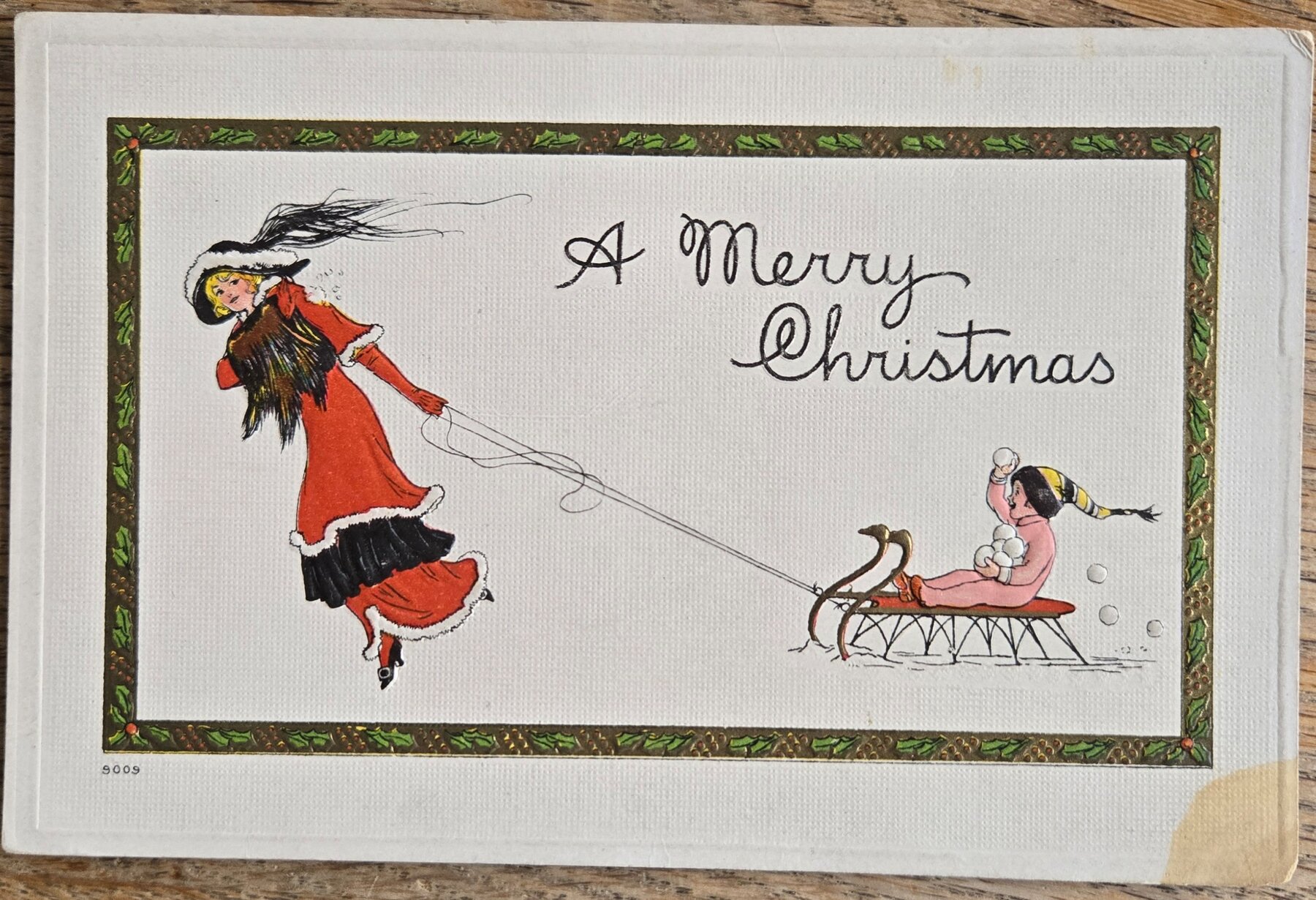 Merry Christmas Woman Red Coat Pulling Child Sled Snowball Bergman Postcard c1910